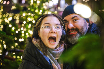 Cheerful Christmas Girl with Her Father and Festive Lights