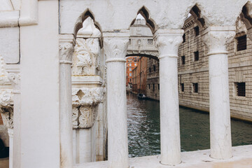 Fototapeta premium Venice canal view through Doge's Palace columns