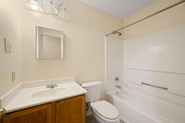 A wellequipped bathroom featuring a toilet, sink, and a bathtub
