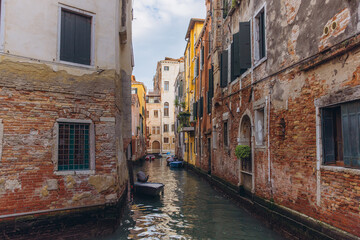 Venice canal with old historic crumbling buildings