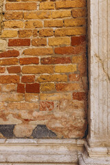 Old brick wall and stone column in Venice Italy
