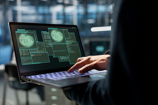 Closeup of data center employee managing global server infrastructure, ensuring uptime across international networks. Technician monitors worldwide system operations, maintaining secure cloud services