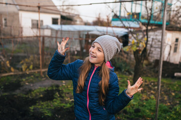 A photograph of a beautiful teenage girl with dirty hands, covered in soil, black soil, and earth...