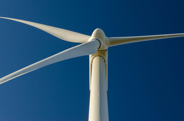 Close up white wind turbine blades clean energy engineering design copy space.