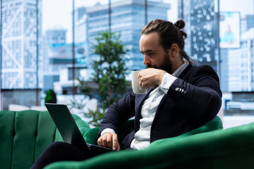 Male leader sitting in a smart office demonstrating authority and productivity, showcasing...
