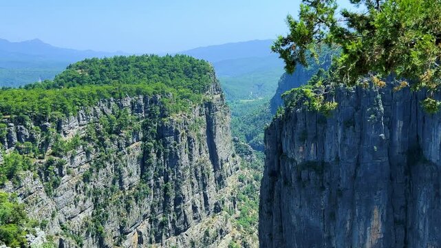 A mountain valley landscape with forests and cliffs. Huge rocks and rocky outcrops. A beautiful deep canyon with lots of tourists. A bird's-eye view of the Tasi Canyon. T&uuml;rkiye	