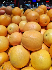 Oranges in supermarket. Market stalls are filled with ripe fresh citrus fruits