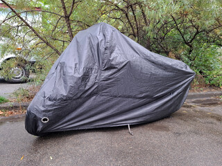 Black nylon cover on a parked motorcycle © Harmony Video Pro