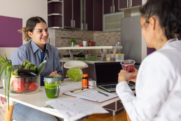 Woman discussing healthy diet with nutritionist at home