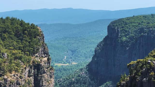 A mountain valley landscape with forests and cliffs. Huge rocks and rocky outcrops. A beautiful deep canyon with lots of tourists. A bird's-eye view of the Tasi Canyon. T&uuml;rkiye	