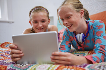 House, girls and kids with tablet, smile and bonding together with happiness, internet and teenager. Apartment, children and tech with social media, funny video and notification for online game