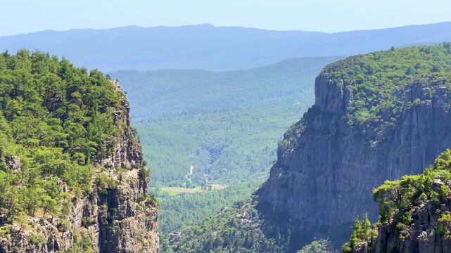 A mountain valley landscape with forests and cliffs. Huge rocks and rocky outcrops. A beautiful deep canyon with lots of tourists. A bird's-eye view of the Tasi Canyon. T&uuml;rkiye