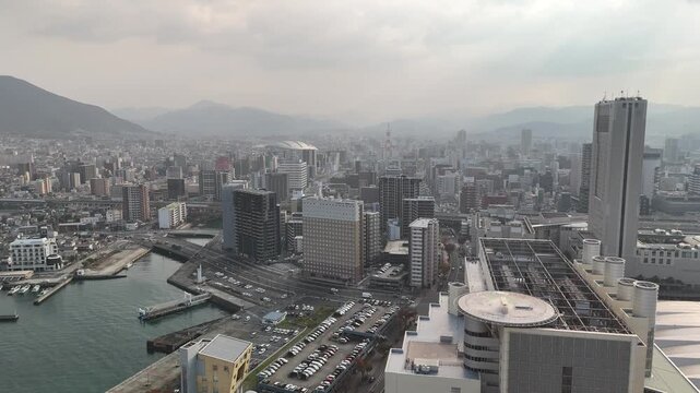 Kitakyushu City, Fukuoka Prefecture, Kyushu, Japan: 4K Aerial Drone Footage of Waterfront Skyline, Urban Districts, High-Rise Buildings, Skylines and Mists Over Mountains