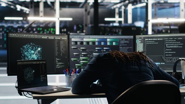 Irked data center IT expert smashing desk, upset by malfunctioning gear while using node tree software. Mad server hub engineer disgruntled by errors, using glitching AI visualization tech, camera B