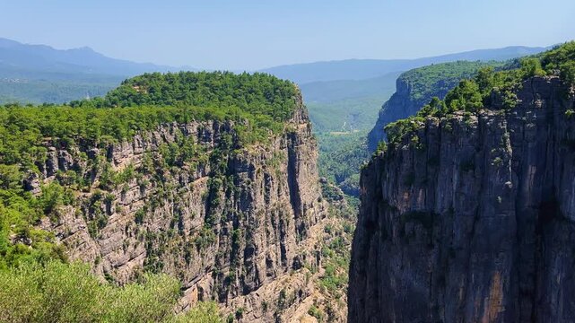 A mountain valley landscape with forests and cliffs. Huge rocks and rocky outcrops. A beautiful deep canyon with lots of tourists. A bird's-eye view of the Tasi Canyon. T&uuml;rkiye