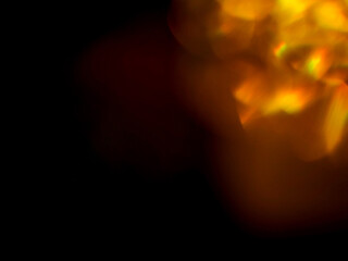 Colorful light leaks on black background for design and special effects. Retro film look. Abstract colorful light beams.