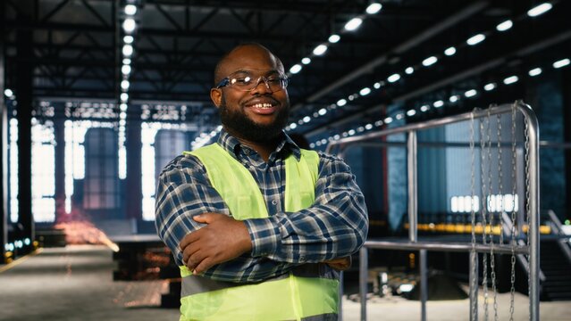 Factory personnel inspecting steel machinery in a warehouse plant, highlighting the professional job role, engineering precision and the large scale power of industrial production.