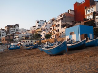 Traditional blue fishermen's boats at sunset on the beach in Taghazout, Morocco