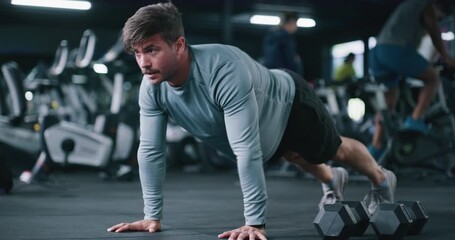 Man, fitness and gym with push ups for workout, arm exercise or lifting body weight on floor. Active, male person or training chest with core strength for muscle gain or wellness in health club - Powered by Adobe