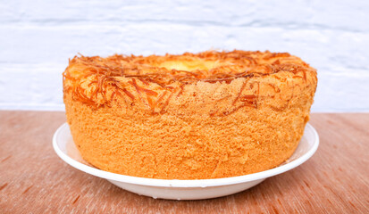 chiffon cake with cheese flavor on white plate. Fresh Baked chiffon Fluffy Cake with Grated Cheese on the table