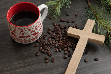 Wood cross with cup of coffee and beans with Christmas background
