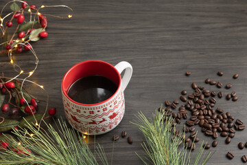 Christmas mug of coffee with a holiday border on dark wood