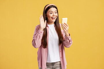 Happy young woman waving and talking during a video call on smartphone