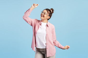 Young woman dancing with happiness and excitement, celebrating success