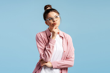 Woman in glasses thinking, having an idea or decision, contemplating solution