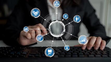 A businesswoman interacts with a digital network interface, representing connectivity and innovation in technology and e-commerce solutions while using a keyboard. Crux