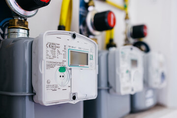 Digital energy meters mounted on a wall, showcasing modern technology with clear displays and...