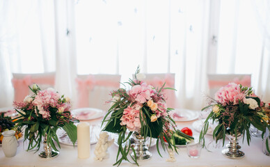 Wedding reception table decorating with floral arrangements