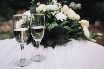 Champagne flutes celebrating special occasion with flowers