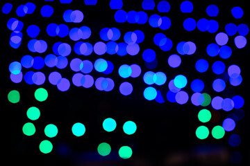 Blue and green bokeh lights creating festive background