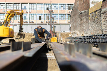 Welder working with welding machine on construction site