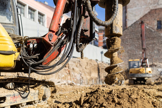 Heavy drilling machine creating deep foundations for building