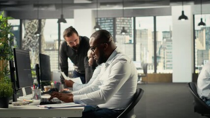 Employees team discussing business intel and performance in modern space. Multinational company staff members reviewing reports, forecasts and diagrams to align strategy. Camera B. - Powered by Adobe