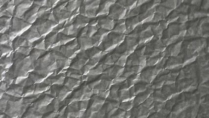 Crumpled creased gray glossy shiny wrapping paper textured background for product presentation packaging and label design