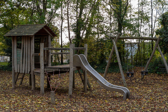 Empty playground in autumn forest setting