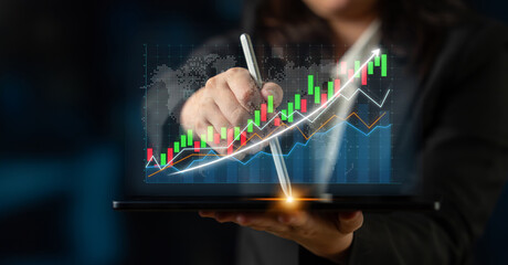 A business professional uses a digital tablet to analyze growth trends, featuring vibrant stock market charts and modern technology reflecting finance insights. Impute