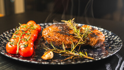 Whole rare rump steak served on a beautiful plate, topped with garlic and rosemary. Steam rising from the juicy meat with a golden crust. Ready to eat, gourmet presentation.