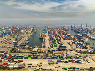 Port area with containers and cargo cranes. Tanjung Priok sea port. Indonesia.