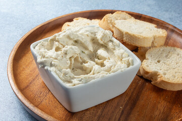 A view of a square bowl of dairy-free artichoke jalapeno dip.