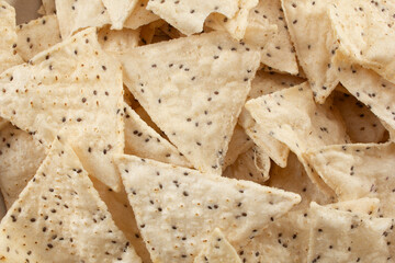 A top down view of a pile of cassava tortilla chips, as a background.