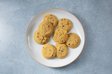 A top down view of a plate of gluten-free, dairy-free chocolate chip cookies.