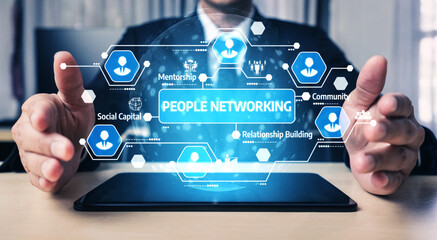 This image depicts a business professional using a tablet to visualize networking concepts such as mentorship and relationship building, emphasizing digital communication. Tessel
