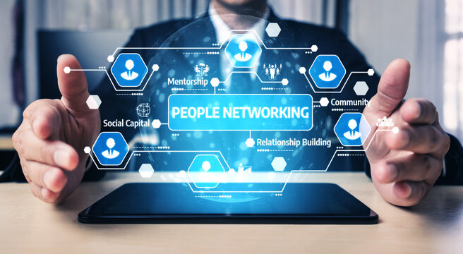 This image depicts a business professional using a tablet to visualize networking concepts such as mentorship and relationship building, emphasizing digital communication. Tessel - Powered by Adobe