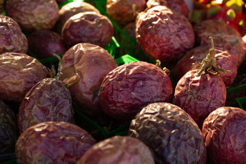 A view of several cartons full of passion fruit, seen at the farmers market.