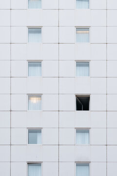 Bright grey building with an open window
