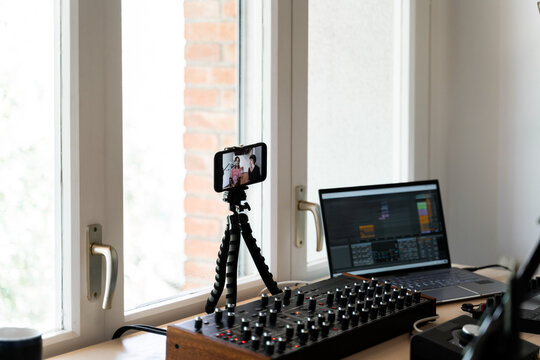 Music studio with phone recording friends playing